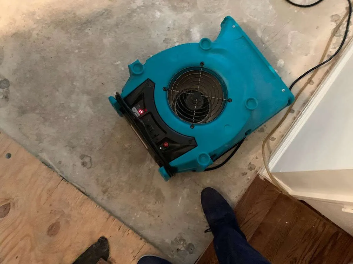 Air mover drying subfloor during Commercial Water Damage Restoration in Dulles Town Center